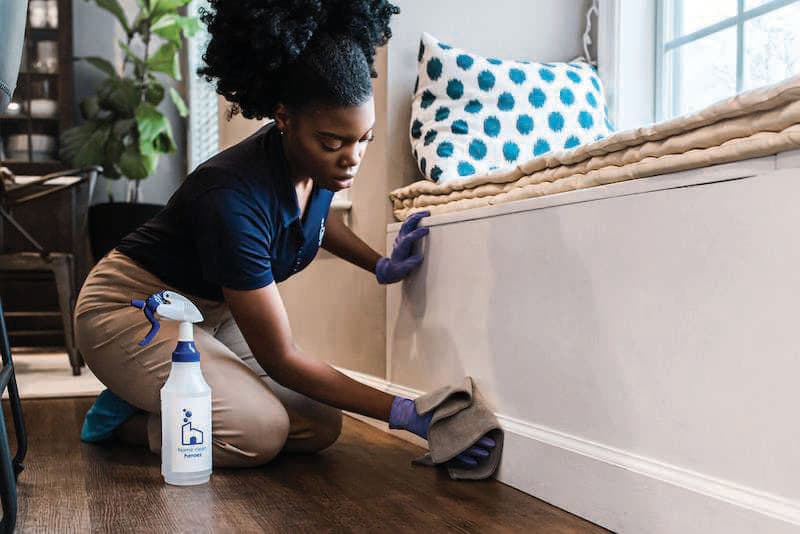 Bright Task cleaner wiping a skirting board