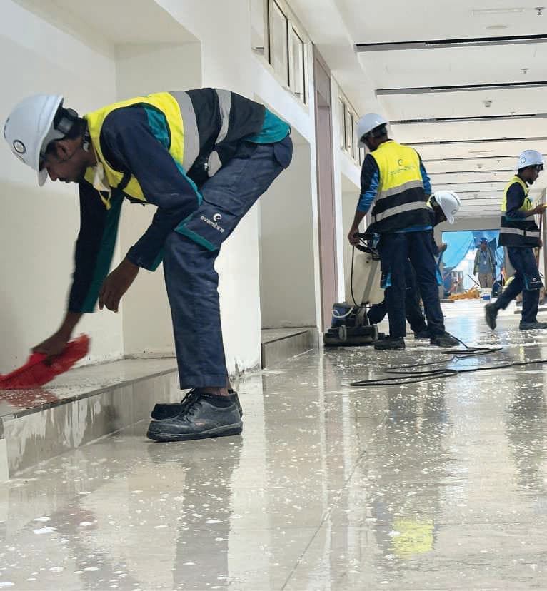 Bright Task team in safety gear cleaning a corridor